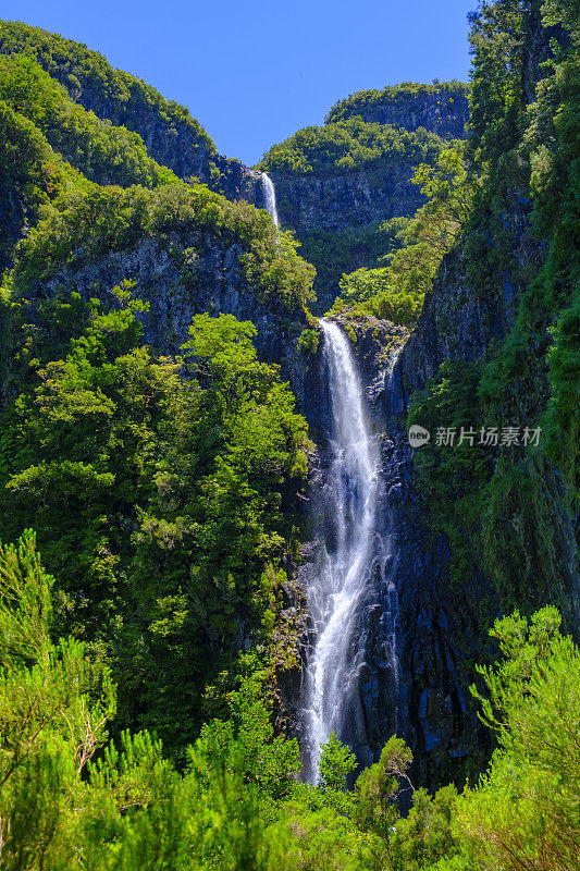 Risco waterfall in the mountains near Rabaçal and Levada do Risco walkway on Madeira island during a beautiful summer day